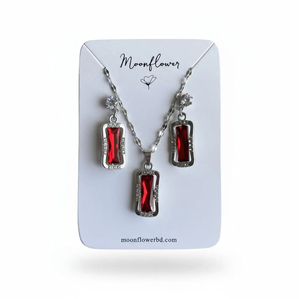 Jewelry set with red stones on a 'Moonflower' branded card.