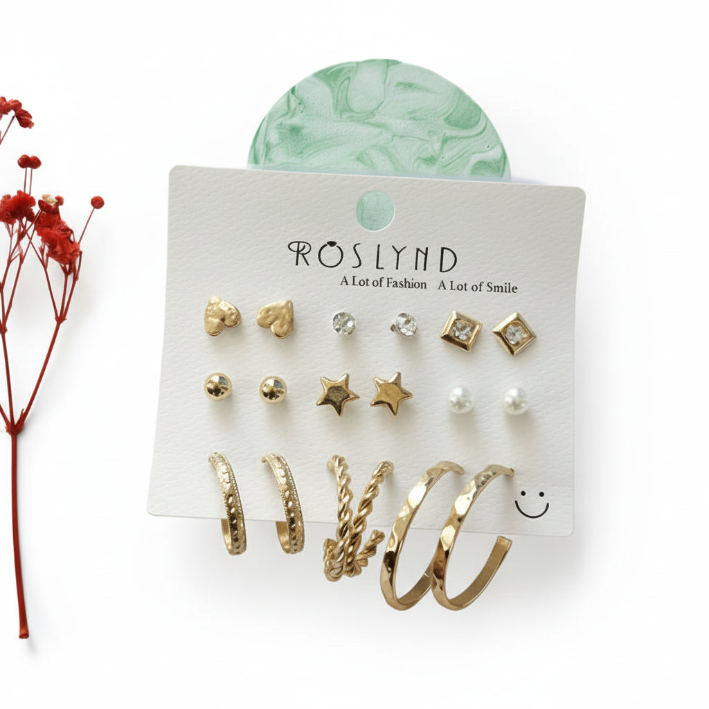 Set of gold earrings on a Roslynd branded card with a red flower and green decorative item in the background.