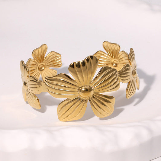 Gold floral bracelet on a white background