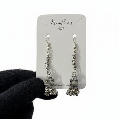 Pair of silver earrings on a 'Moonflower' branded card against a white background.