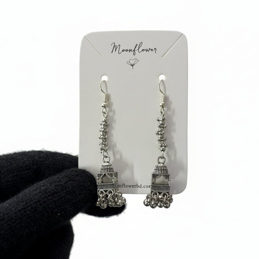 Pair of silver earrings on a 'Moonflower' branded card against a white background.