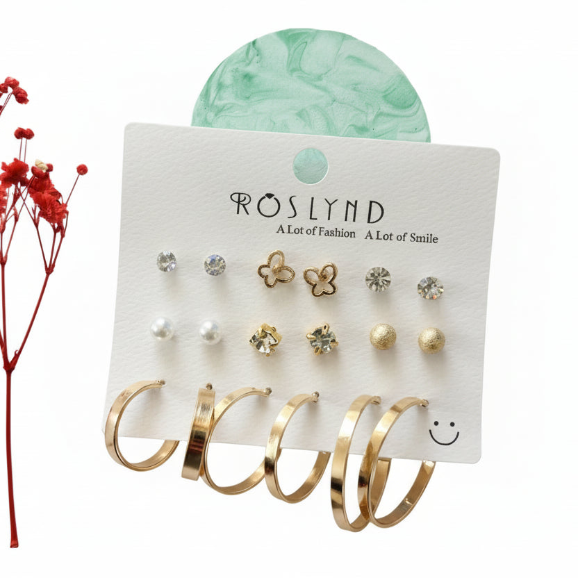 Set of earrings on a branded card with a red flower on the side.