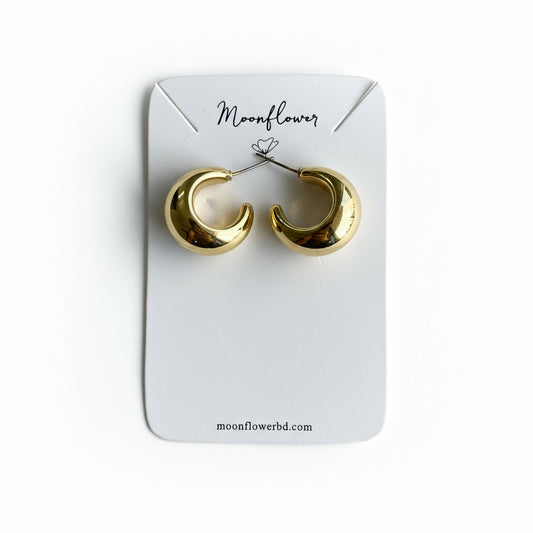 Gold hoop earrings on a 'Moonflower' branded card.