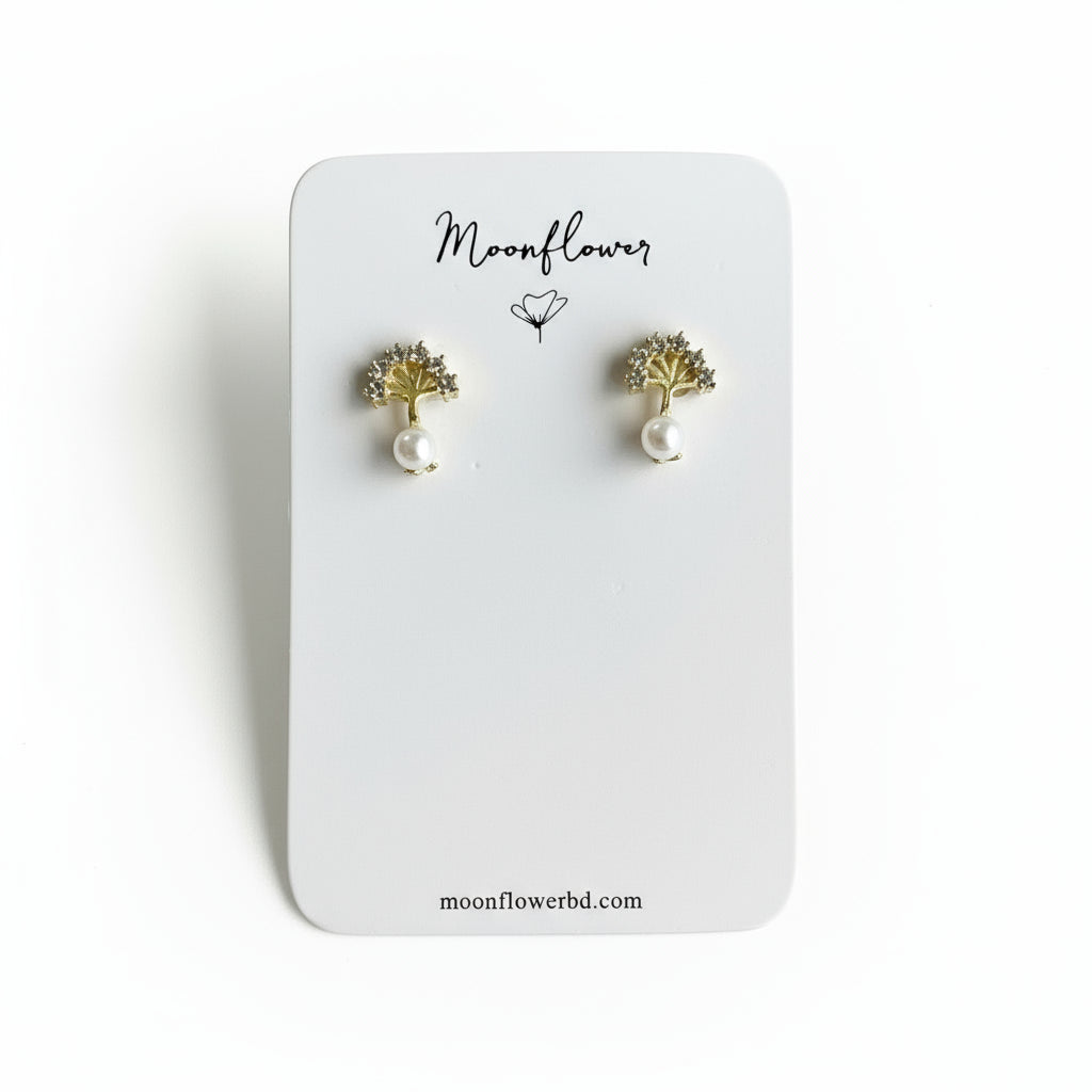 Pair of gold and pearl earrings on a 'Moonflower' branded card.