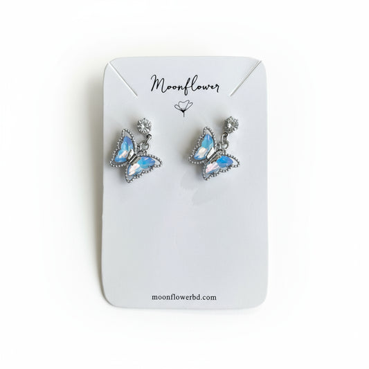 Butterfly-shaped earrings on a 'Moonflower' branded card.