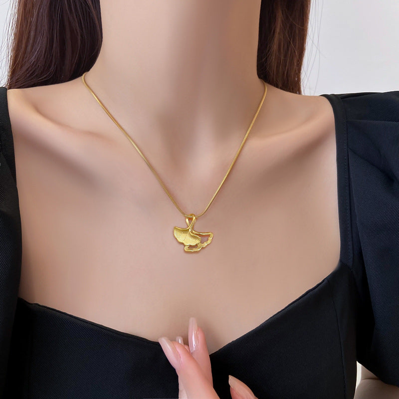 Gold necklace with a pendant on a mannequin