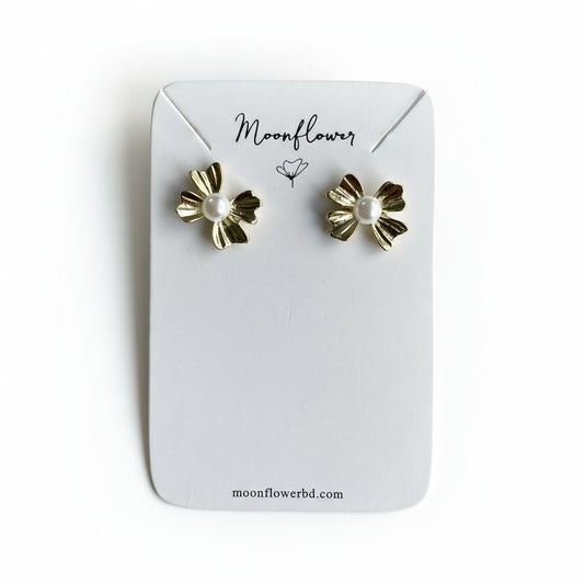 Gold flower-shaped earrings on a Moonflower branded card.