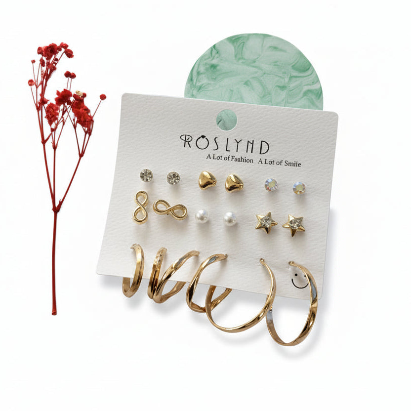 Set of earrings on a branded card with a red floral arrangement on a white background