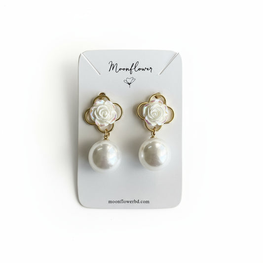 Pair of earrings with pearl-like beads and gold accents on a Moonflower branded card.