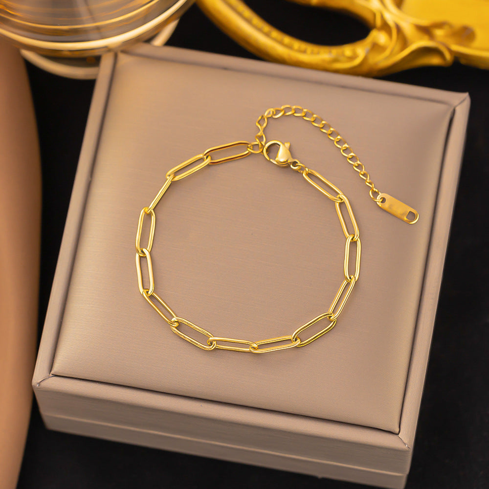 Gold chain bracelet on a jewelry box with a dark background