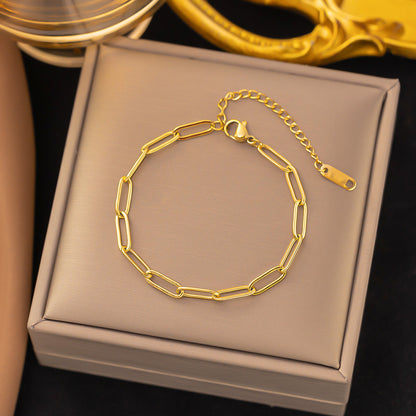 Gold chain bracelet on a jewelry box with a dark background