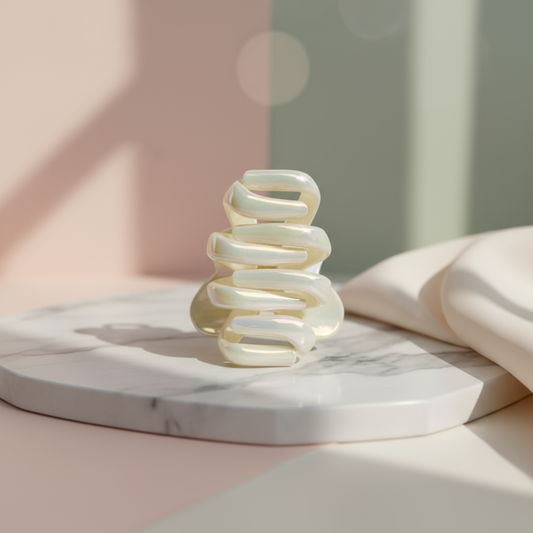 Ivory spiral hair clip on a white background