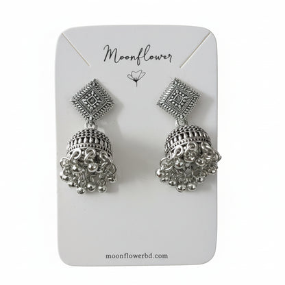 Silver earrings on a 'Moonflower' branded card with a white background