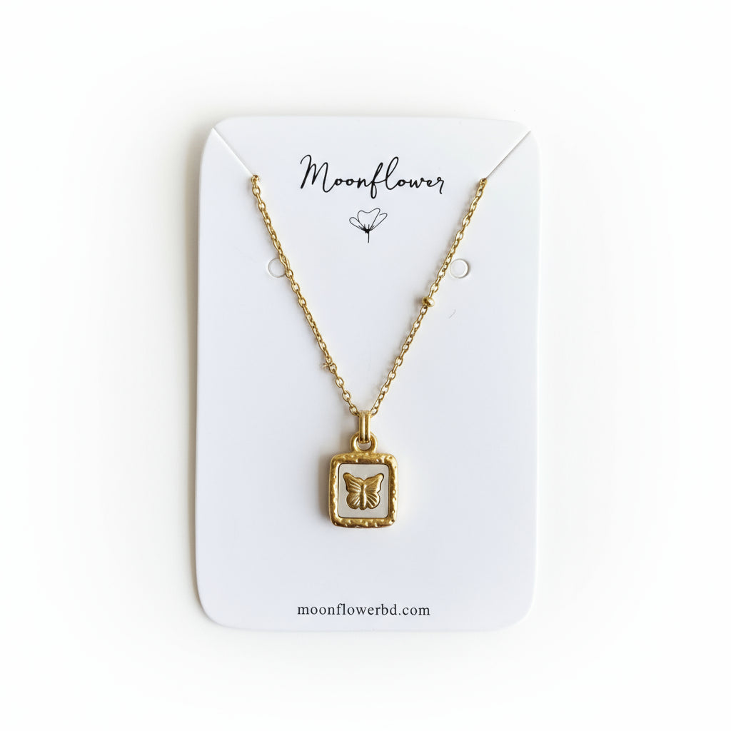 Gold necklace with a pendant on a Moonflower branded card.