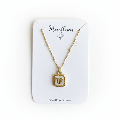 Gold necklace with a pendant on a Moonflower branded card.