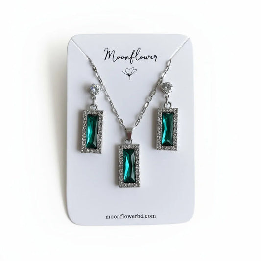 Jewelry set with green gemstones on a 'Moonflower' branded card.