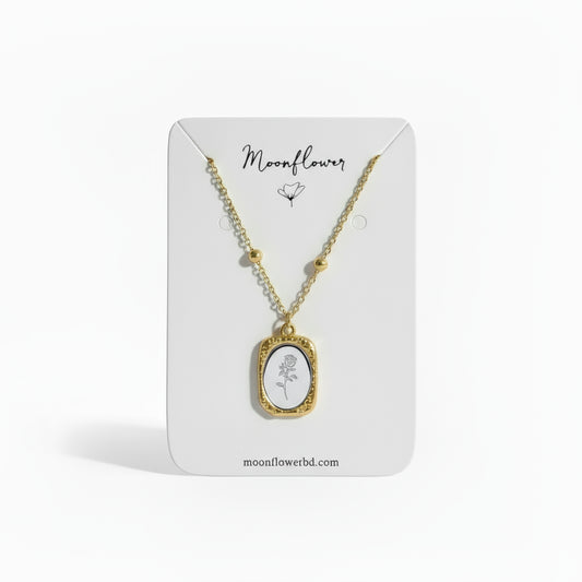 Necklace with a pendant on a display card labeled 'Moonflower'.