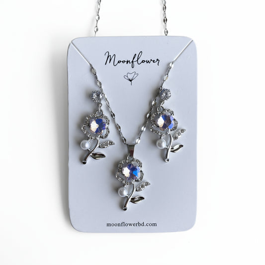 Jewelry set with necklace and earrings on a 'Moonflower' branded card.