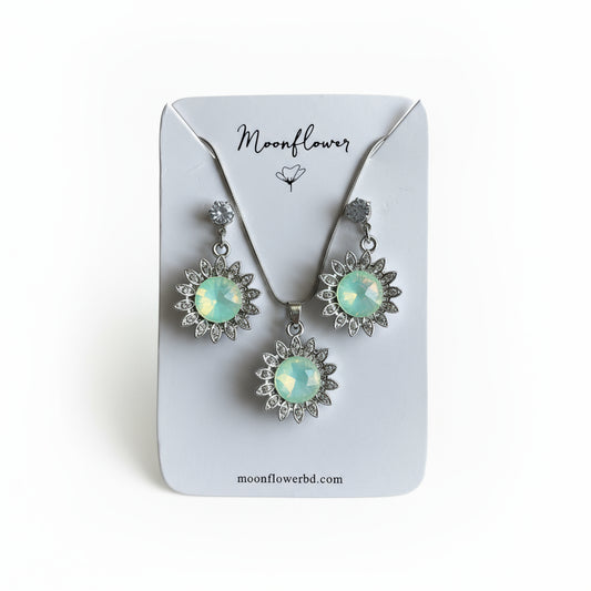Pair of earrings on a 'Moonflower' branded card.