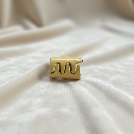 Yellow hair clip on a beige fabric background